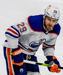 Ice hockey player looking towards his right.