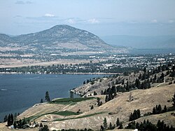 An aerial view of Penticton; the Skaha Lake can be seen in the foreground, while the Okanagan Lake is visible in the background. Penticton Regional Airport's runway can also be seen.