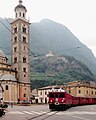 Ein Zug der Berninabahn vor der Wallfahrtskirche "Madonna di Tirano" in Tirano, Italien (Woche 25)