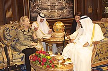 Photograph of Secretary of State Clinton meeting with King Abdullah of Saudi Arabia. She is seated on the left, he is on the right. Their interpreters are in the background.
