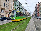 Green track tramline with Moderus Beta tram in Poznań, Poland