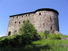 The remains of Raseborg Castle, a large brick building.