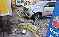 A vehicle damaged by falling debris.