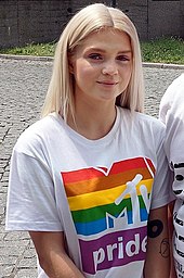 Smiling Margaret wearing a white t-shirt with MTV Pride logo.