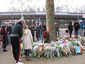 Local residents bring flowers to commemorate the victims of the tram attack