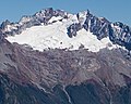 Sharkfin Tower, Boston Peak, and Sahale Peak surround the Quien Sabe Glacier in this view from Hidden Lake Peaks