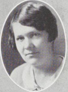 A young white woman with dark hair cut in a bob with a side part, in an oval frame