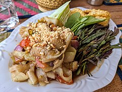 Lao-style green papaya salad (left) served with raw sprigs of water mimosa (right)