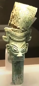 Bronze figure wearing an officer's cap with towering headdress, excavated in 2021
