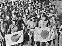 More captured Japanese flags. 26 September 1943: soldiers from the 2/6th Independent Company display Japanese flags they captured during the battle of Kaiapit between 19 and 20 September 1943. AWM photo 057510