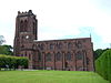 A stone Gothic Revival church with a battlemented tower