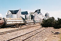 Well-built homes are reduced to a short pile of medium-sized debris on the foundation. Homes with poor or no anchoring are swept completely away. Large, heavy vehicles, including airplanes, trains, and large trucks, can be pushed over, flipped repeatedly, or picked up and thrown. Large, healthy trees are entirely debarked and snapped off close to the ground or uprooted altogether and turned into flying projectiles. Passenger cars and similarly sized objects can be picked up and flung for considerable distances.