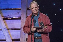 Michael Morpurgo on stage accepting an award.