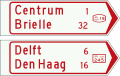 K7: Wegwijzer voor fietsers en bromfietsers (handwijzer), met lokaal doel, interlokaal doel, stedelijk fietsroutenummer (boven), en met interlokale doelen en interlokaal fietsroutenummer (onder)[20]