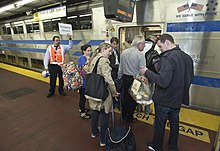 Passengers boarding a C3 car – one of two designated for Hamptons Reserve service – at Penn Station in 2013