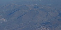 Aerial view of the hills North of Rahovec with the small village in the centre