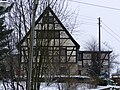 Wohnstallhaus (Nr. 13) eines Bauernhofes, mit Hofbaum (auf dem Grundstück von Nr. 15)