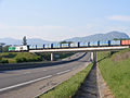 crosses the RD884 near Farges (the daily municipal waste train is seen, heading for Bellegarde)