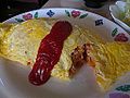 Omurice (Japanese omelette rice) cut open, with fried rice inside