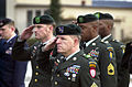 During a Fallen Soldier Ceremony at Ramstein Air Base, Germany, one of the flag draped coffins (not shown) containing the remains of one of 6 coalition soldiers, killed in Kuwait during a training exercise March 12 2001, is rendered a salute from a formation of Army Green Berets, as it is carried off a C-17 Globemaster III aircraft (not shown) for transportation to the Landstuhl Regional Medical center for identification.