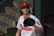 Aaron Nola sitting, glove extended.