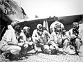 Fliers of a P-51 Mustang Group of the 15th Air Force in Italy `shoot the breeze' in the shadow of one of the Mustangs they fly.