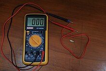 The red light on the multimeter indicates continuity