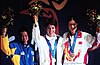 Gold medalist Nancy Johnson (centre) of the U.S., raises her hands with silver medalist Cho-Hyun Kang (left), of Korea, and bronze winner Jing Gao (right), of China, during the first medal ceremony of the 2000 Olympic Games (16 September 2000).
