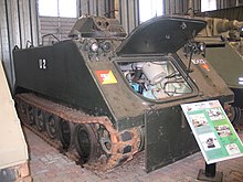 Colour photo of a green tracked military vehicle