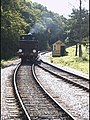 Steam engine running around its train.