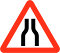 Road narrows on both sides