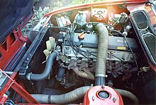 An image showing a 2.3 litre engine installed in a red Rover SD1 model