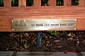 The bench's bottom plaque