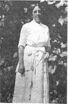 photograph is Katherine Sleeper Walden circa 1910. She is wearing a white dress and has a key hung about her waist. This photo's source claims a large significance of the key, but this is not verifiable.