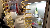 Working inside a BSL-4 lab with air hoses providing positive air pressure