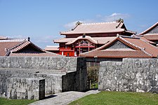 A view of Shuri castle, ornate with elements of Chinese architecture, from behind its front wall