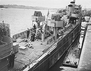 Sailors and workmen on a ship in dock