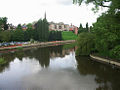 A view from the bridge looking downstream. The Abbey Gardens are on the right.