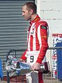 Olympiacos driver Chris van der Drift with his podium trophies at Silverstone (2010)