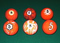 The 5 balls from various unusual, decorative sets of pocket billiards (pool) balls.