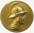 Eucratides I wearing the Bactrian version of the Boeotian helmet, shown on his gold 20-stater, the largest gold coin ever minted in the ancient world, c. 2nd century BC. of Greco-Bactrian Kingdom Bactrian Kingdom Greco-Bactria Graeco-Bactria