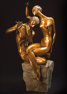 Sculpture of a man playing a flute as a woman listens