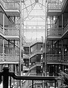 HABS interior photograph of the central court of the Bradbury Building, emphasizing the ornamental ironwork on the stairways and open walkways and the large skylight.