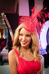 An image of a wax statue resembling Kylie Minogue, wearing a pink headpiece and dress.