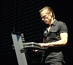 Larry Mullen playing keyboards.