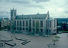 A 1980s photograph of Gerberding Hall on the University of Washington campus as seen across a brick square