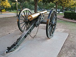 Photo shows a Civil War era cannon with a copper-colored gun barrel.