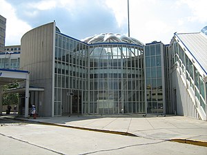 A domed glass building with blue and white trim