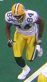 Javon Walker running on a football field in uniform