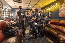 The Godz backstage in 2023 (L–R): Steve Mitchell, Sav Ramey, Mark Chatfield, Julie Neal, Keith Pickens